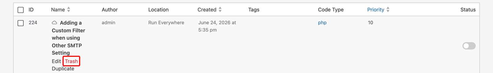 The Code Snippets list in WPCode with the Trash option on a snippet